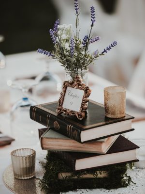 Books on table with lavender and candles